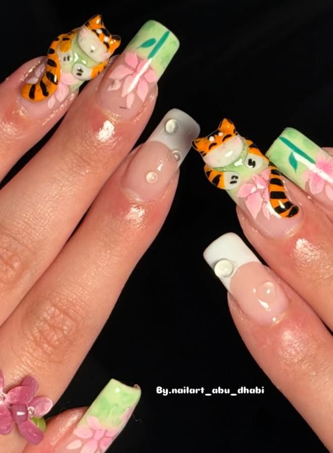 Long square nails with hand-sculpted tiger and blossom charms