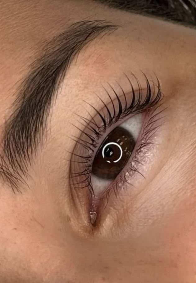 Close-up of eyelash extensions and a shaped brow